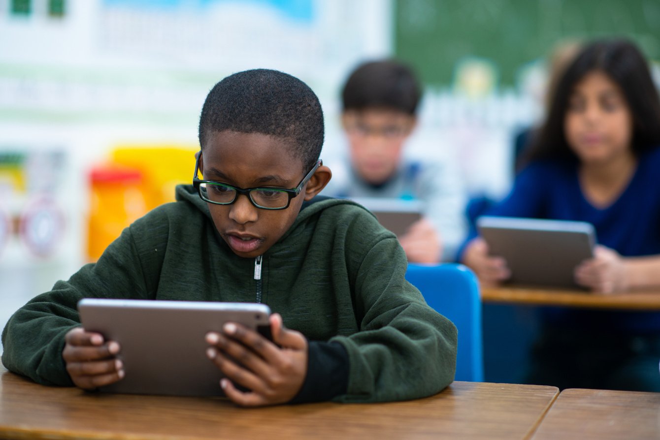 Elementary School Students Using Technology stock photo